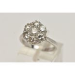 AN 18CT WHITE GOLD DIAMOND CLUSTER RING, set with seven round brilliant cut diamonds, estimated