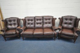 A DARK BROWN LEATHER THREE PIECE CHESTERFIELD LOUNGE SUITE, comprising a winged three seater settee,