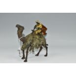 A COLD PAINTED BRONZE OF AN ARAB ON A CAMEL WITH LION ATTACKING AFTER BERGMAN, unmarked, height 17cm