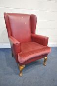 A RED LEATHERETTE WING BACK, with a fabric cushion, on beech cabriole legs