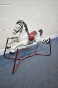 A VINTAGE SPRUNG CHILDS ROCKING HORSE (condition report: missing handles, well used condition)