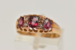 AN EARLY 20TH CENTURY RUBY AND DIAMOND RING, set with three graduated oval cut rubies, interspaced