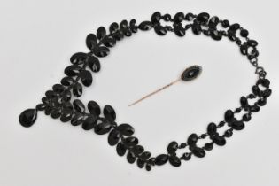 A STICK PIN AND NECKLACE, a navette cabochon onyx collet set in yellow metal, unmarked, together
