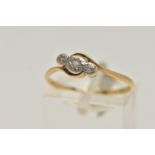 A YELLOW AND WHITE METAL THREE STONE DIAMOND RING, three small single cut diamonds, star set in a