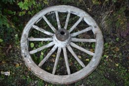 A WEATHERED CART/WAGGON WHEEL, diameter approximately 120cm (condition - weathered, losses to