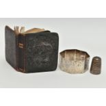 A MINIATURE BIBLE, THIMBLE AND A NAPKIN RING, silver embossed cherub front to the bible hallmarked