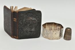A MINIATURE BIBLE, THIMBLE AND A NAPKIN RING, silver embossed cherub front to the bible hallmarked