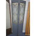 TWO GLAZED TWO PANEL FLOOR SCREENS, one painted with Art Nouveau glazing, the other with frosted
