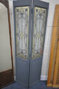 TWO GLAZED TWO PANEL FLOOR SCREENS, one painted with Art Nouveau glazing, the other with frosted