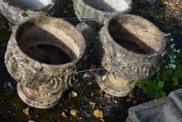 A PAIR OF COMPOSITE GARDEN URNS, with scrolled and foliate details, on a separate base, diameter