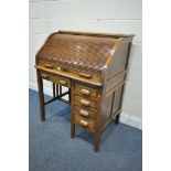 AN EARLY TO MID 20TH CENTURY OAK ROLL TOP DESK, enclosing an arrangement of pigeon holes, over