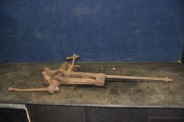 A VINTAGE CAST IRON LEG VICE length 105cm (Condition rusty and may need attention to be usable)
