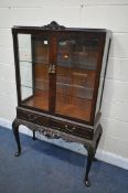 AN VICTORIAN STYLE MAHOGANY TWO DOOR DISPLAY CABINET, with two glass shelves and two drawers, on
