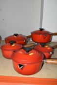 A SET OF FIVE LE CREUSET RED SAUCEPANS, all with lids, comprising sizes 14,16,18,20,22 (5) (