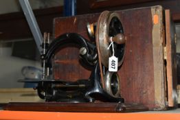 A CASED WILLCOX & GIBBS PORTABLE SEWING MACHINE, late nineteenth century, hand crank, remains of