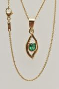 AN EMERALD PENDANT, oval cut emerald, bezel set with an open work mount, large tapered bail, stamped