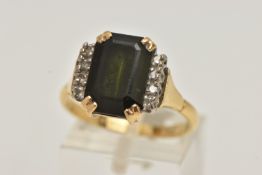 AN 18CT GOLD GREEN TOURMALINE DRESS RING, rectangular cut green tourmaline prong set with eight