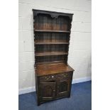 A SLIM OAK DRESSER, with two drawers, width 80cm x depth 47cm x height 187cm x height of base
