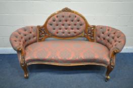 A VICTORIAN WALNUT BUTTONED SOFA, with open foliate decoration, on scrolled front legs, length 185cm
