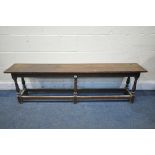 A LONG EARLY 20TH CENTURY OAK BENCH, on six turned uprights, united by stretchers, length 168cm x