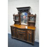 AN EDWARDIAN WALNUT MIRRORBACK, with an arrangement of mirrors, drawers and cupboard, width 149cm