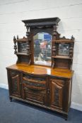 AN EDWARDIAN WALNUT MIRRORBACK, with an arrangement of mirrors, drawers and cupboard, width 149cm