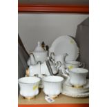 A ROYAL ALBERT 'VAL D'OR' DESIGN TEA SET, comprising cake plate, teapot (marked as second quality,