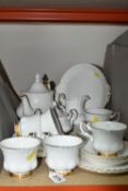 A ROYAL ALBERT 'VAL D'OR' DESIGN TEA SET, comprising cake plate, teapot (marked as second quality,