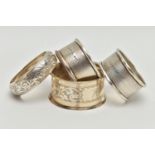 FOUR SILVER NAPKIN RINGS, non-matching, various patterns, each with a full silver hallmark for