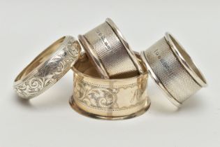 FOUR SILVER NAPKIN RINGS, non-matching, various patterns, each with a full silver hallmark for