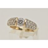 A 14CT GOLD CUBIC ZIRCONIA RING, designed as a central circular colourless cubic zirconia flanked by