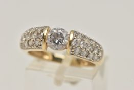 A 14CT GOLD CUBIC ZIRCONIA RING, designed as a central circular colourless cubic zirconia flanked by