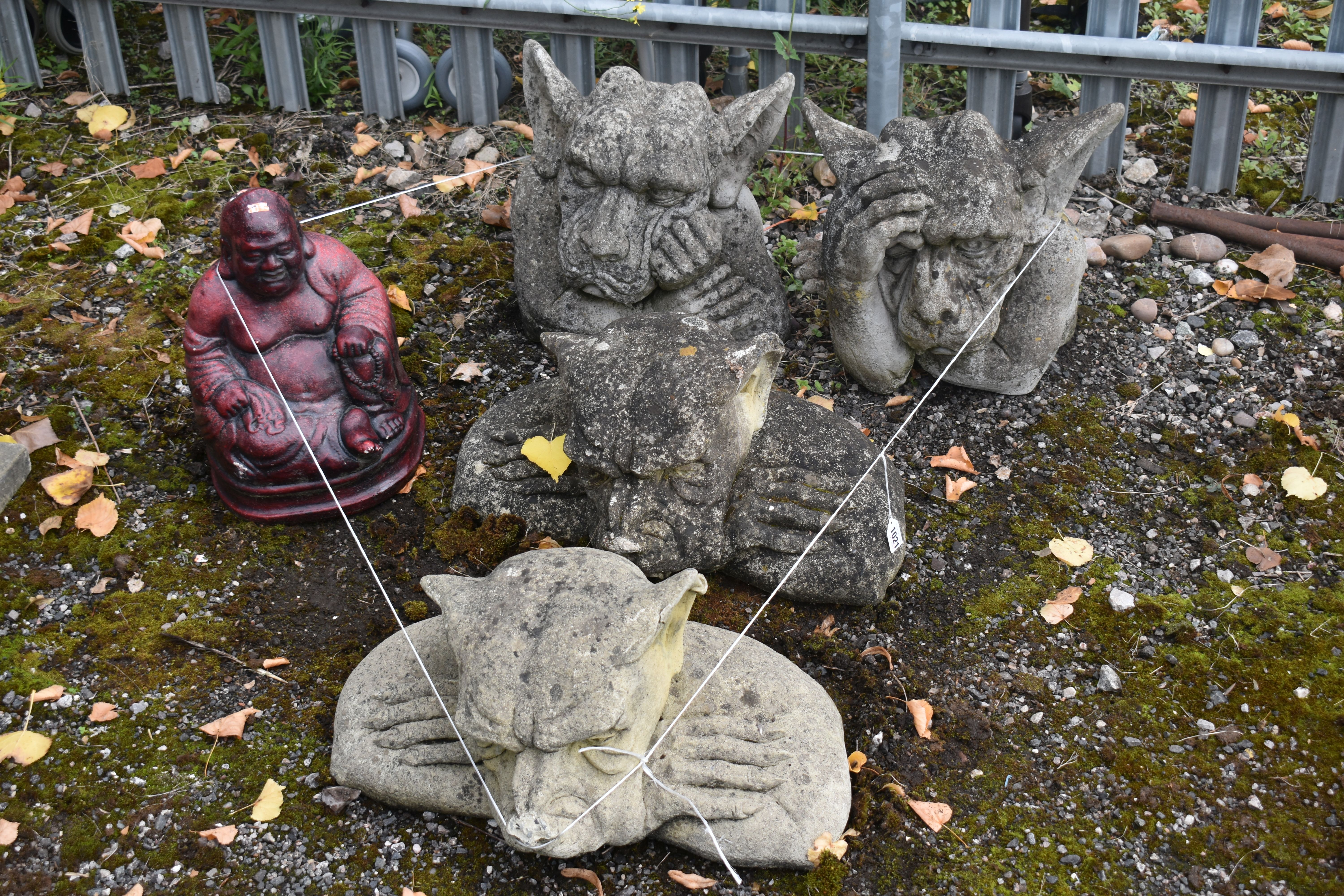 FOUR COMPOSITE GARDEN FIGURES OF A GROTESQUE, and a burgundy painted figure of a Buddha (5)