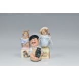 THREE ROYAL WORCESTER AND ROYAL DOULTON CANDLE SNUFFERS, comprising Royal Worcester Beatrix Potter