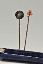 TWO YELLOW METAL STICK PINS, the first set with coral cabochons, unmarked pin, the second of a