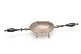 A DOUBLE HANDLED DISH, white metal dish with four feet and two black painted wooden handles
