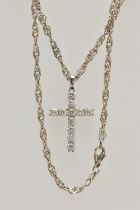 A WHITE METAL DIAMOND CROSS PENDANT AND A CHAIN, the cross pendant claw set with eleven round