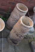 A PAIR OF TERRACOTTA CYLINDRICAL TAPERED CHIMNEYS, with central floral decoration, height 52cm (