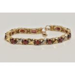 A 9CT GOLD AND GARNET BRACELET, twelve oval cut garnets, prong set in yellow metal, interspaced