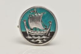 AN IONA BROOCH BY ALEXANDER RITCHIE, of circular outline depicting a Viking ship with guilloche
