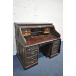 AN EARLY 20TH CENTURY MAHOGANY ROLL TOP DESK, the tambour is enclosing a fitted interior, over