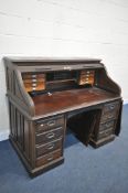 AN EARLY 20TH CENTURY MAHOGANY ROLL TOP DESK, the tambour is enclosing a fitted interior, over