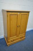 A LIGHT OAK PANELLED TWO DOOR CUPBOARD, with a single drawer, width 91cm x depth 59cm x height 132cm