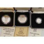 THREE CASED SILVER FALKLAND ISLAND COINS, together with written information leaflets