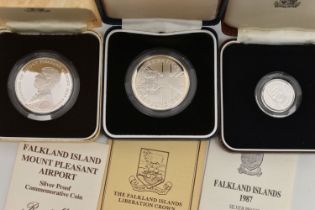 THREE CASED SILVER FALKLAND ISLAND COINS, together with written information leaflets