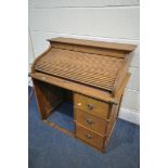 A SMALL MID CENTURY BEECH ROLL TOP DESK, with three drawers, width 78cm x depth 48cm x height