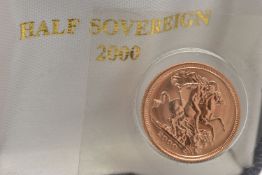 A HALF SOVEREIGN COIN, 2000 George and the Dragon, Elizabeth II, encased in plastic casing
