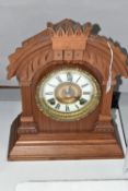 A LATE 19TH CENTURY WALNUT CASED AMERICAN ANSONIA MANTEL CLOCK, the carved pediment above enamel