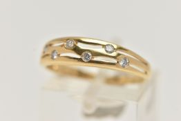 AN 18CT GOLD DIAMOND DRESS RING, the tapered band with pierced detail, flush set with six