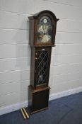 AN OAK CHIMING LONGCASE CLOCK, the brass dial with moonphase movement, Roman numerals, and chiming